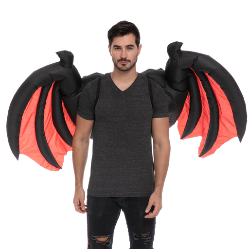 A man wearing a pair of Adult Inflatable Demon Wings