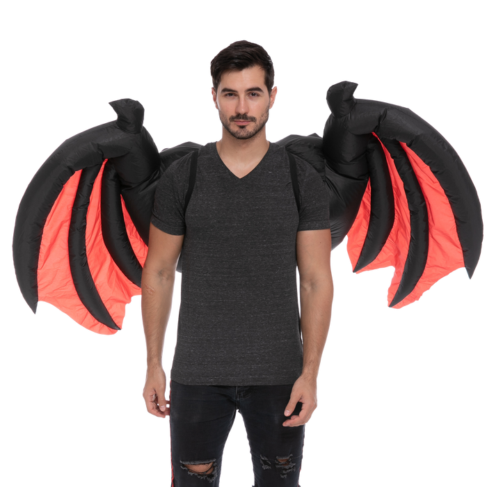 A man wearing a pair of Adult Inflatable Demon Wings