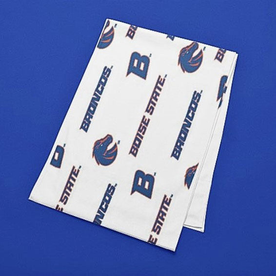 A folded 13" x 72" Boise State University Vinyl Table runner.