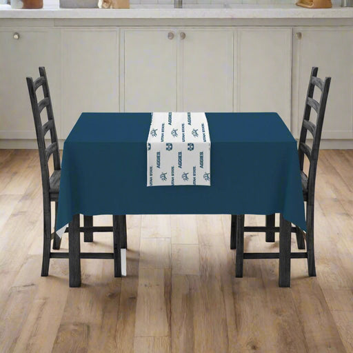 A USU Vinyl Table Runner mocked up in a table setting. 